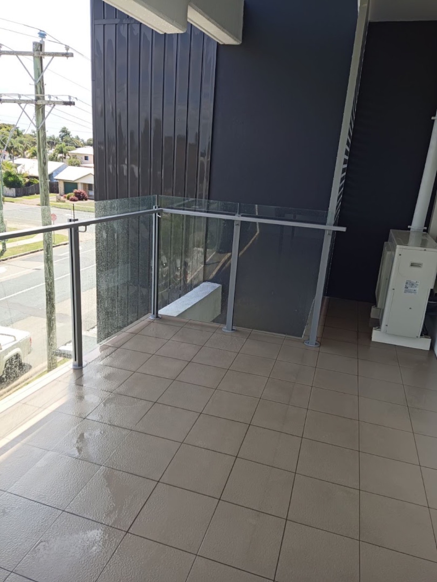 A glass balustrade on a tiled balcony