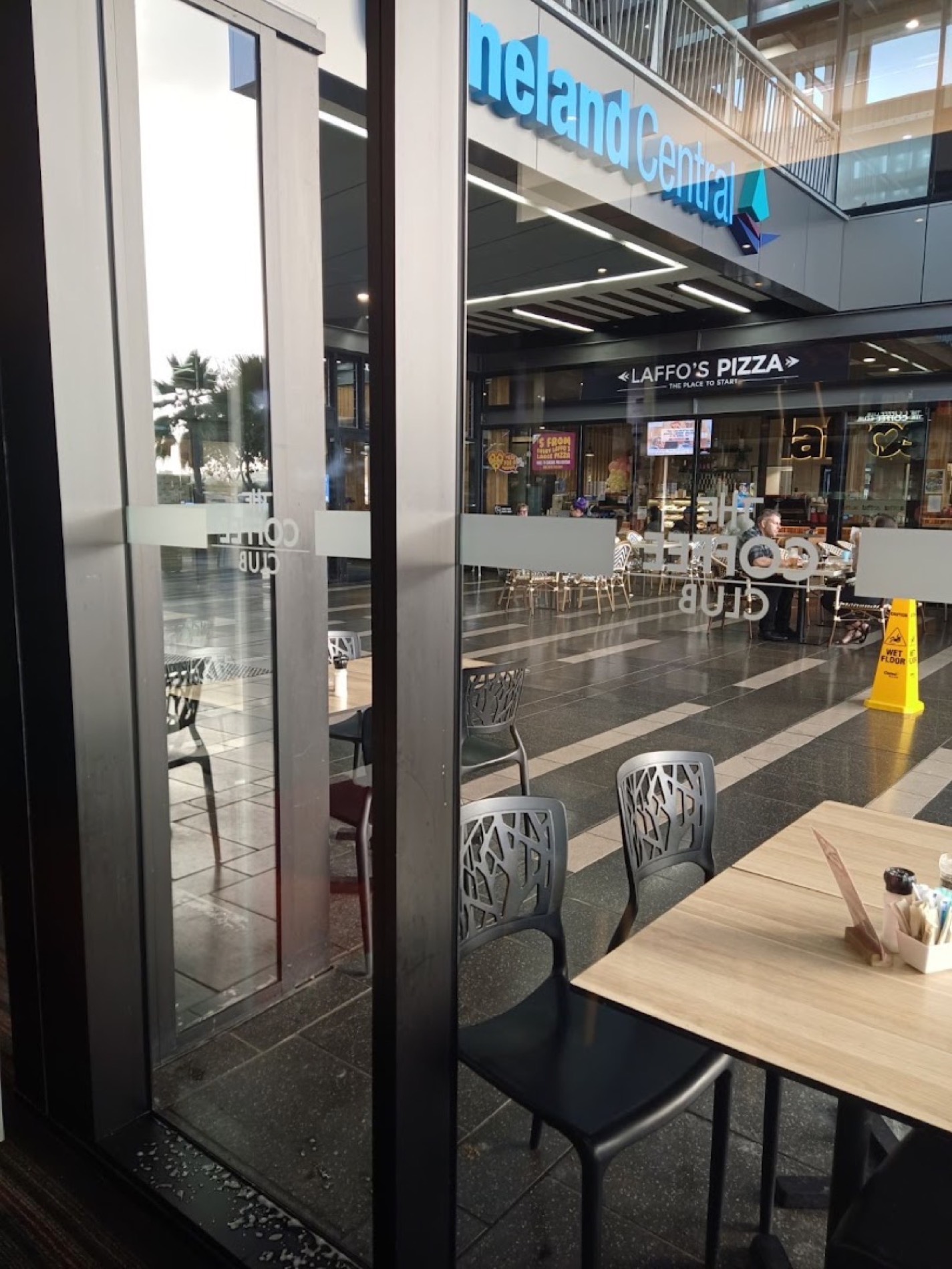 The glass frontage of a shopping centre walkway
