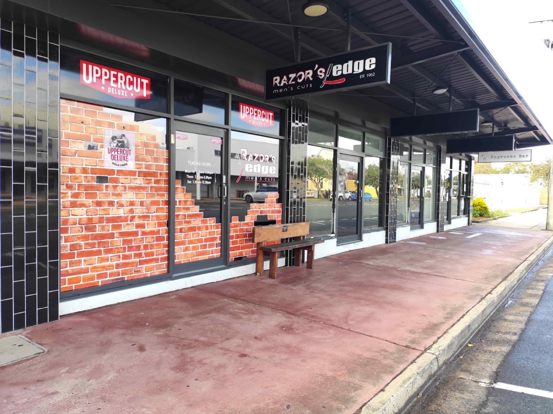 The glass shopfronts along a row of shops in Mackay