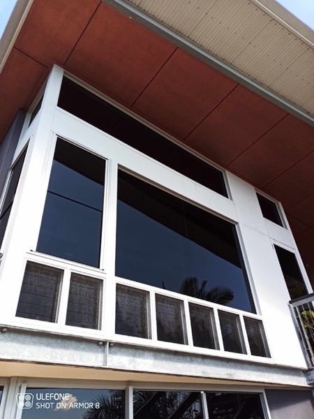 The white-framed windows of a house