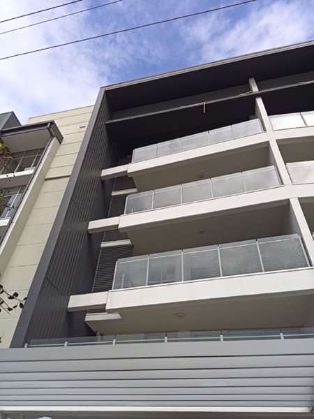 The louvred facade of a modern multi-storey building