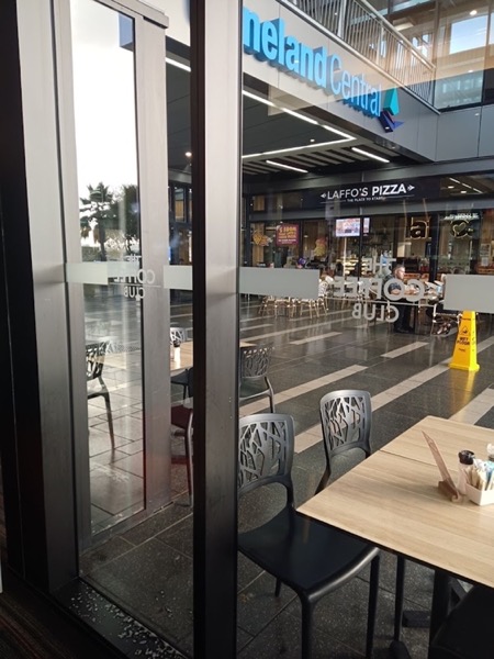 The glass frontage of a shopping centre walkway
