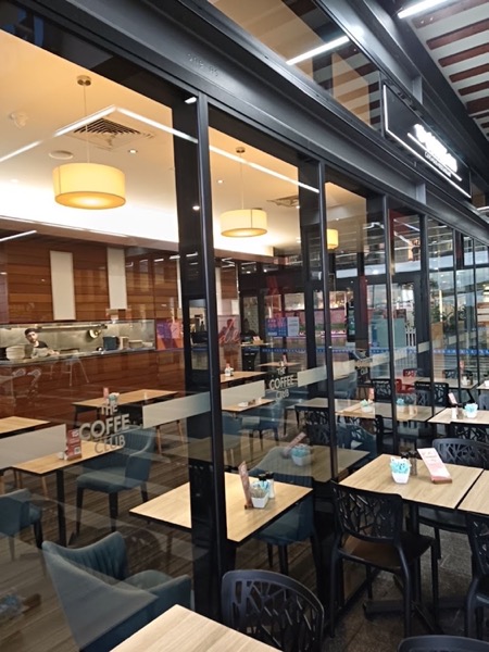 Glass windows and doors along the front of a cafe dining room