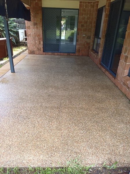 An exposed aggregate driveway at the entry to a house